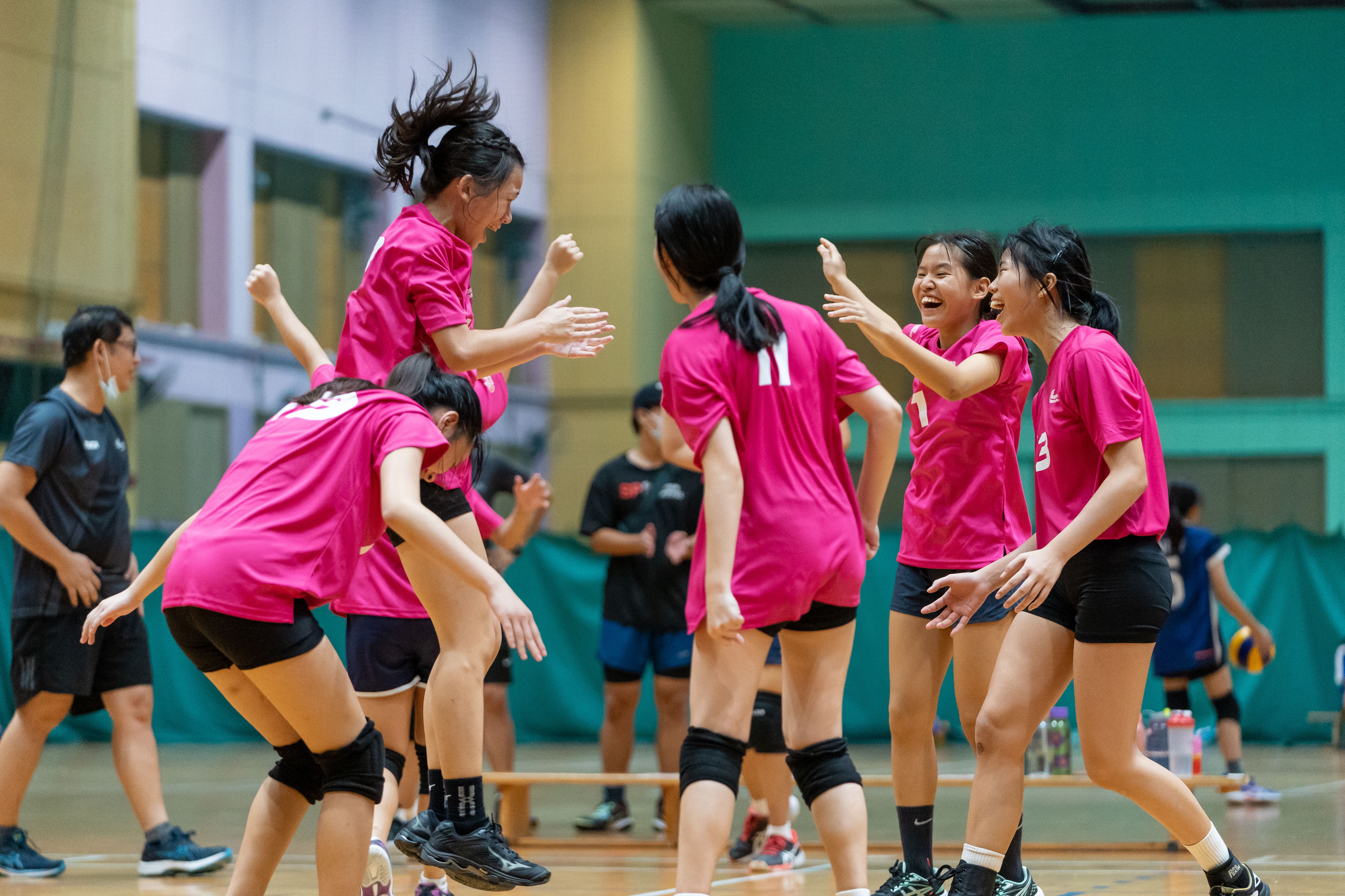 Volleyball players celebrate mid-match